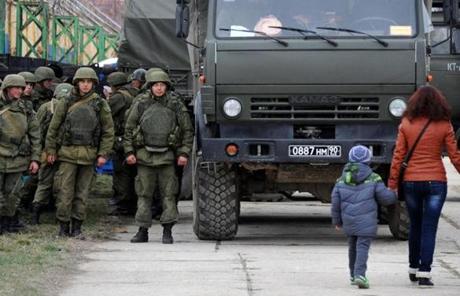 Military personnel stood near a Russian-made truck in the eastern Crimean port city of Feodosiya.
