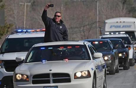 A police officer shot photos from a sunroof in the convoy.
