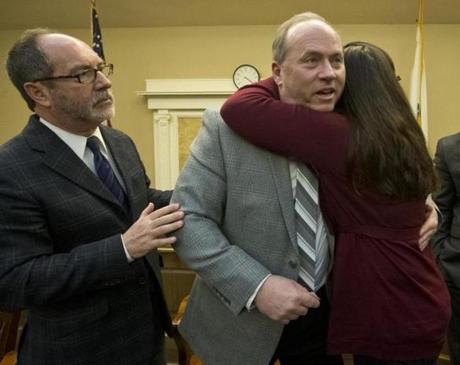Lou Pelletier hugged his daughter Jessica after discussing the plight of his other daughter, Justina, at the State House Thursday. The Rev. Patrick Mahoney also attended the briefing. 
