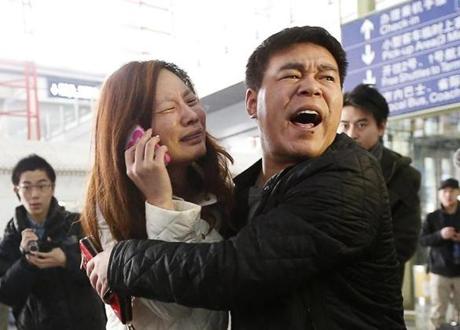 A relative of a passenger who was aboard the flight cried as she talked on her cellphone Saturday in Beijing.
