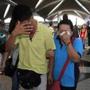 A woman wiped away tears after walking out of the reception center and holding area at the airport in Kuala Lumpur for family and friend of passengers aboard a missing Malaysia Airlines plane.
