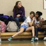 Joita Diecidue, far right, gets a hug from teammmate Sarina DaRosa during home game at the Lincoln school in Brookline, when it seemed like their team had a chance in game against the Heath School.