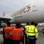 Workers gathered to watch as the first Emirates flight landed at Logan International Airport.