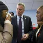Mayor Bill de Blasio and his wife, Chirlane McCray (right), comforted a displaced woman.