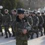 Ukrainian servicemen are pictured at the entrance to a base in the village of Lyubimovka, near Sevastopol, on Saturday.