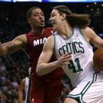 Kelly Olynyk drve past Heat forward Michael Beasley en route to a layup in the first half. 