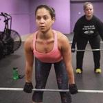 Christine Koesler (left) and Nykie Marzilli prepare to lift at CrossFit in Cambridge.