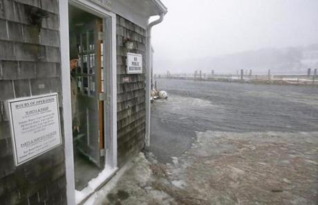 Alan Cohen, owner of the Ryder's Cove Marina, watched rising water and slush approach his office door in Chatham.
