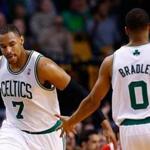 Jared Sullinger is congratulated by teammate Avery Bradley after a three-point basket against the Toronto Raptors in the second half.