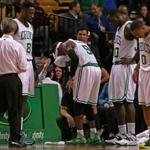 A towel pressed to his forehead after sustaining a third-period cut, the Celtics’ Rajon Rondo leaves the court for repairs.