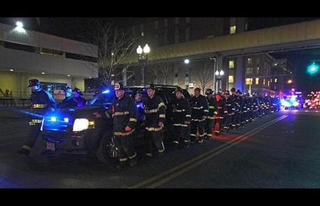 Firefighters escorted the body of one of the fallen firefighters from Boston Medical Center to the medical examiner’s office late Wednesday.
