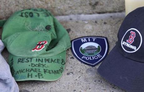 A baseball cap with a written tribute to fallen firefighter Michael Kennedy was placed at the memorial.
