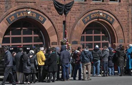 Visitors and media lined up outside fire station on Boylston Street.

