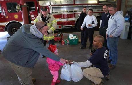 Needham firefighter Tommy O'Brien and his daughter, Peyton, 3, dropped off food at the firehouse on Boylston Street. 
