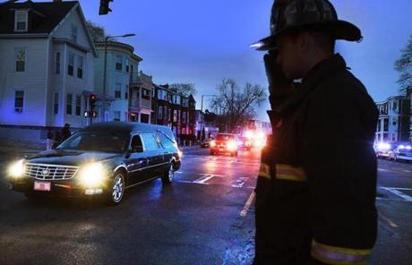 Kevin Preston of Engine 21 saluted a motorcade carrying one of the fallen firefighters to a West Roxbury funeral home.
