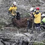 Workers using rescue dogs probed the debris Sunday for victims of a mudslide.