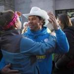 Carlos Arredondo participated in a group photo at the Boston Marathon finish line.