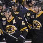 Bruins center David Krejci (46) celebrates with teammates after scoring a goal during the first period Saturday.