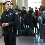 “My goal,’’ says Officer Corey Santasky, pictured mingling with students between classes at Reading High School, “is to make sure they can trust me, that I’m a resource for them.”