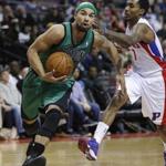 Celtics guard Jerryd Bayless drives past the Pistons’ Brandon Jennings on Saturday night.