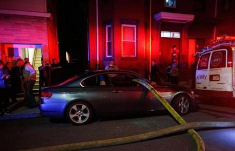 Firefighters broke the windows of a car to make room for a hose.
