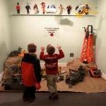 Brothers Xavier (left) and Deacon Parsons of Salem study the Wenham Museum’s G.I. Joe display.