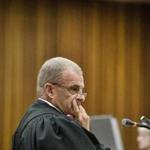 Prosecutor Gerrie Nel looked on Thursday while Oscar Pistorius testified during his murder trial.