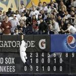 Yankees right fielder Ichiro Suzuki catches a drive to the wall by David Ortiz in the eighth inning. 