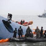 South Korean rescue team members searched for passengers aboard a ferry sinking off South Korea's southern coast.