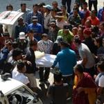 Nepalese relatives and volunteers carried the body of a Mount Everest avalanche victim on Saturday after its arrival at the Sherpa Monastery in Kathmandu.
