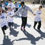 Students join Kenyan elite runner Jemima Sumgong for a lap around the grounds of the Elmwood Elementary School in Hopkinton on Thursday, while Wilson Chebet gets an enthusiastic welcome by second- and third-graders in the school’s gymnasium. 