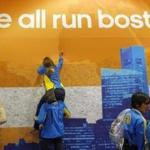 Runners added their messages to a cloth banner after picking up their official bib numbers for the 2014 Boston Marathon, which will feature a field of about 36,000.