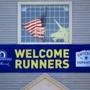 A banner on the Boston Athletic Association building welcomes runners to Hopkinton.