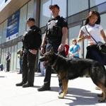 Police and a bomb-sniffing dog stood by on Boylston Street Monday near the scene of the bombings.