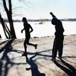 Ni Vo, right, of Dorchester did warm-up exercises before her run around Jamaica Pond in March. 