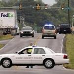 Law enforcement officers respond to a shooting at a FedEx facility in Kennesaw, Ga.