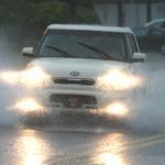 A vehicle drives through heavy flooding on Thomas Drive during rush hour in Panama City, Fla., on Tuesday.