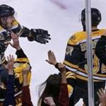 Brad Marchand (left) and the fans celebrated after Patrice Bergeron (right) scored a goal in the third period.