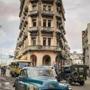 A vintage American car drives along a street in Havana in December.