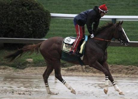 Preakness favorite California Chrome galloped 2 miles at rain-soaked Pimlico on Friday.

