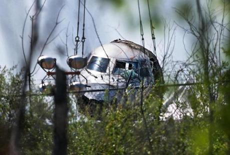 The nose of the private jet that went off the runway and burst into flames Saturday night at Hanscom Field was lifted Tuesday afternoon by a large crane.
