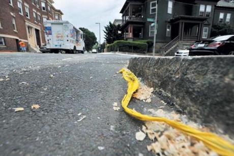 A scrap of police tape marked the spot whereaman was shot to death on Harold Street in Roxbury on Sunday.

