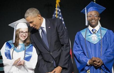 President Obama leaned over to talk to class valedictorian Naomi Desilet at the commencement for Worcester Technical High School.
