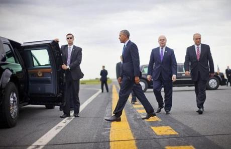Obama walked across the tarmac towards his vehicle after being greeted by Representative Jim McGovern.
