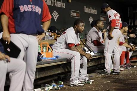 Boston Red Sox starting pitcher Rubby De La Rosa, center, sits in the dugout in the seventh inning of a baseball game against the Baltimore Orioles, Wednesday, June 11, 2014, in Baltimore. De La Rosa was relieved in the sixth. (AP Photo/Patrick Semansky)
