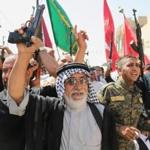 Shi?ite tribal fighters raised their weapons and chanted slogans Saturday in Baghdad as authorities urged Iraqis to help battle insurgents from the Islamic State of Iraq and Syria. 