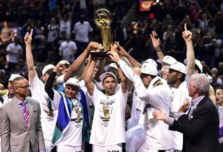 The Spurs celebrated with the Larry O?Brien Trophy after winning the NBA title with a 104-87 win over the Heat in Game 5.
