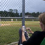 Patty Andresino caught up on her Facebook page while her son, Joe, played for Sullivan Insurance in the Milton Little League playoffs.