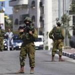 An Israeli soldier stood guard in the West Bank city of Hebron during an operation to locate three missing teenagers. 