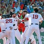 Mike Napoli (second from right) is mobbed by his teammates as he crosses the plate following his walkoff homer in the 10th inning.